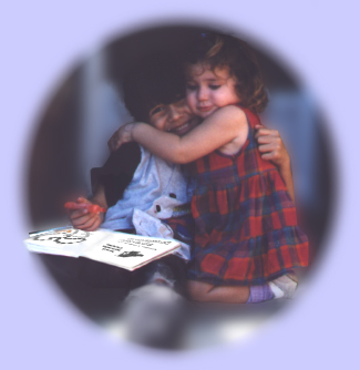 Two chidren enjoying Miss Sabrina's Color the Rosary Book